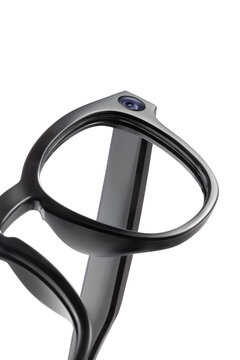 Close up of smart glasses frame with integrated camera lens isolated on white background