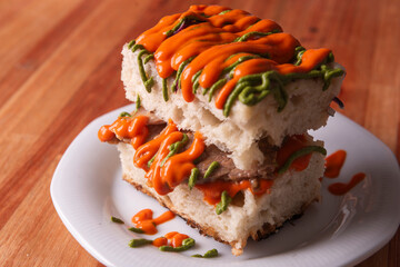 Gourmet focaccia sandwich with roast beef and colorful sauces © santiago