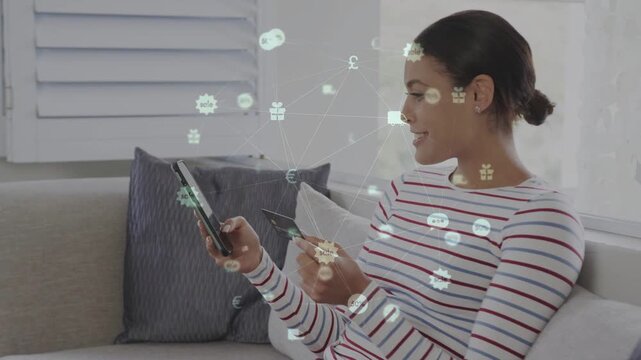 Woman tapping smartphone, holding card on sofa, animating currency icons and confirming payment