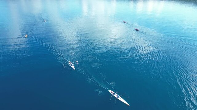 Aerial View of Rowing Race Competition in Turquoise Sea Near Coastal Hills. High quality 4k footage