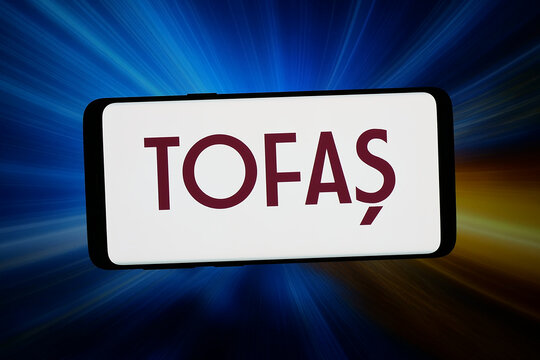 Stuttgart, Germany - 05-18-2026: In this photo illustration, the logo of company TOFAS Turk Otomobil Fabrikasi A.S is displayed on a smartphone in front of abstract background on computer screen.