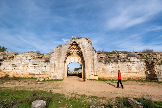 Ruins of a historic Seljuk caravanserai standing within the Mediterranean countryside of Antalya, T&uuml;rkiye, reflecting the architectural heritage of ancient Anatolian trade routes.