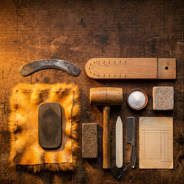 Furrier tools for traditional craftsmanship on wooden table