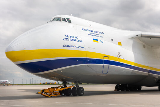 Schkeuditz, Germany - 9 May, 2026. Close-up view Antonov AN124 cargo aircraft parked airport apron dramatic cloudy sky. Aviation massive jet fuselage heavy airfreight transport industrial engineering