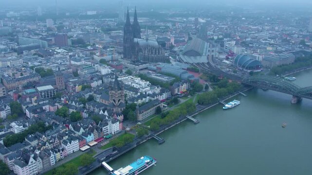  Aerial panorama view above the old town of the city cologne on a rainy, cloudy and foggy morning in summer.