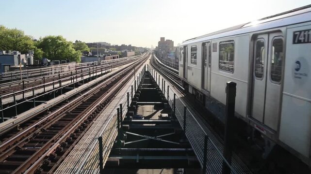 subway train arriving on elevated platform in queens new york city (nyc commuter metro) outdoor stop leaving riding departing ride commute urban raised car