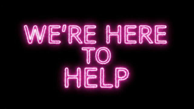 A neon sign on a black background displays the words "WE'RE HERE TO" in bright, pink-purple letters. The glowing effect illuminates the dark space