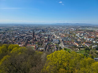 Obraz premium Aerial view above Freiburg downtown with Schlossberg tower minster church and old marketplace panorama