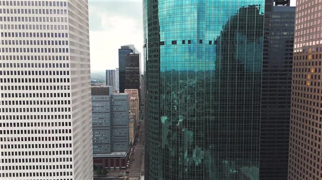 Houston Texas downtown aerial flyby between glass skyscrapers