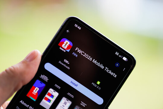 Close-up of a hand holding a smartphone displaying the FWC2026 Mobile Tickets app on the Google Play Store