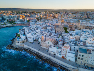 Fototapeta premium Aerial drone panorama view of Monopoli Old Town at sunset, scenic Adriatic sea coastal cityscape in Puglia with historic Italian architecture