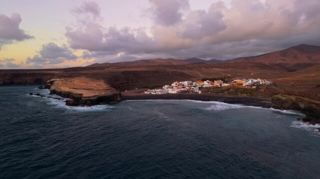 Aerial view of Ajuy village in sunset, which is a region and hamlet in the municipality of Pajara on the island of Fuerteventura, Canary Islands, Spain. Drone POV exploration of Fuerteventura Island. 