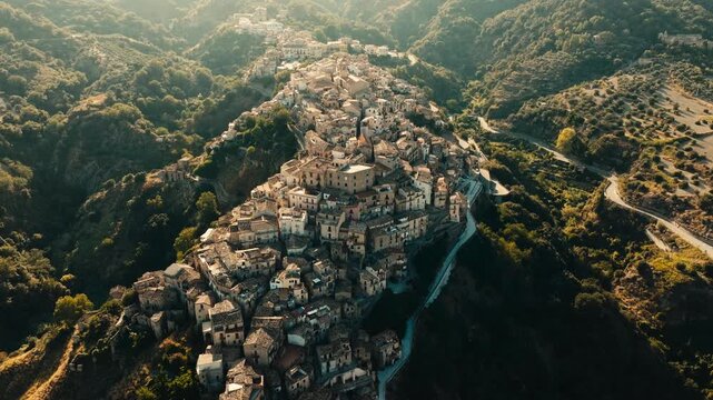 flying over Badolato ancient stone houses at sunset