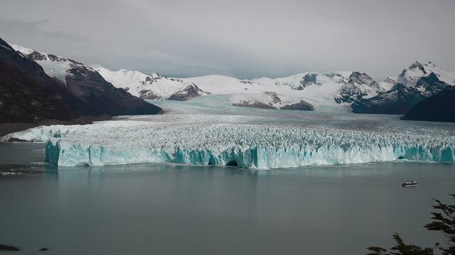 Tour Boat Moving Slowly Along Perito Moreno Glacier in Patagonia