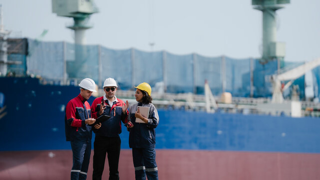 Happy team professional engineer, worker, technician use clipboard discuss work, walk in steel metal manufacture factory plant industry. engineer at commercial shipping port terminal