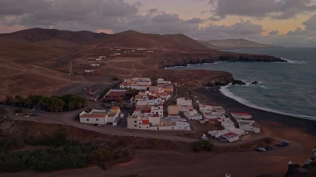 Aerial view of Ajuy village in sunset, which is a region and hamlet in the municipality of Pajara on the island of Fuerteventura, Canary Islands, Spain. Drone POV exploration of Fuerteventura Island. 
