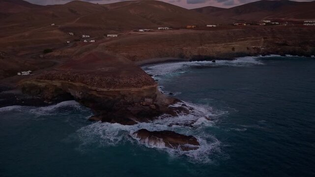 Aerial view of Ajuy village in sunset, which is a region and hamlet in the municipality of Pajara on the island of Fuerteventura, Canary Islands, Spain. Drone POV exploration of Fuerteventura Island. 