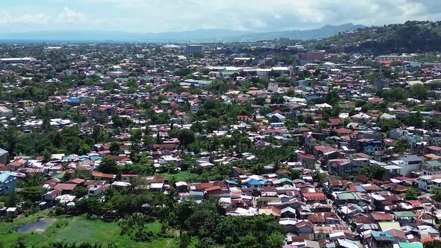 Aerial footage of urban residential environment and tightly packed buildings in Cebu City Philippines.