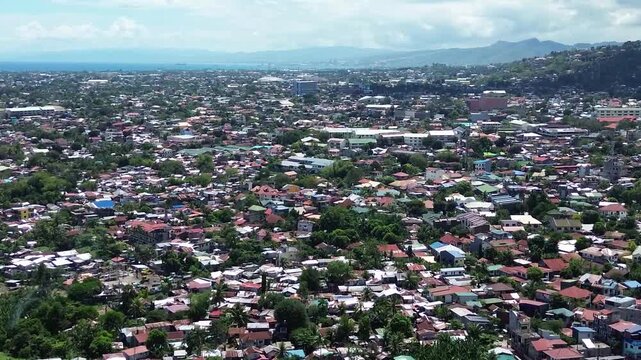 Aerial footage of urban residential environment and tightly packed buildings in Cebu City Philippines.