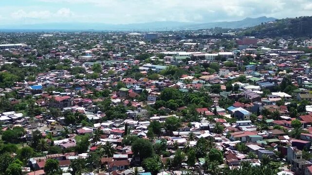 Aerial footage of urban residential environment and tightly packed buildings in Cebu City Philippines.