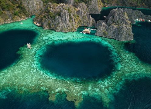 Twin Lagoon, located on Coron Island in Palawan, Philippines, is a breathtaking natural attraction featuring two crystal-clear lagoons separated by a dramatic limestone wall.