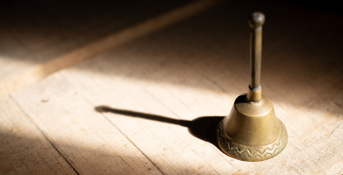 Vintage brass altar bell in natural sunlight