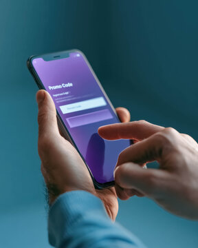 Close up of smartphone with promo code application on mobile screen