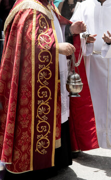 Catholic priest with thurible during procession