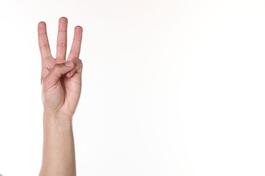 Man showing number three with fingers on white background, closeup. Space for text