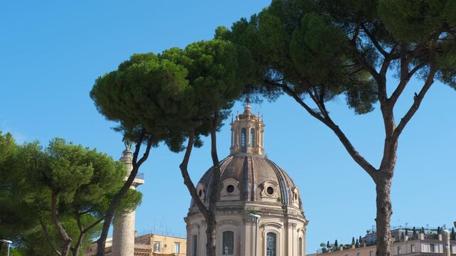 Trajan's column and santa maria di loreto al foro traiano in rome. Slow pan revealing the historic domes of santa maria di loreto and santissimo nome di maria al foro traiano next to trajan's column