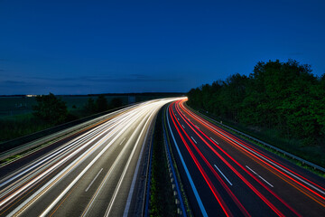 Night highway traffic light trails on curved motorway road - real photography - authentic - no ai - True Long Exposure © Enrico Obergefäll