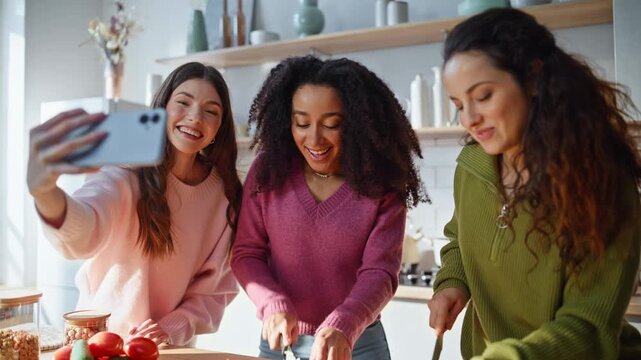 Blogger recording friends cooking at kitchen closeup. Three multi-ethnic women