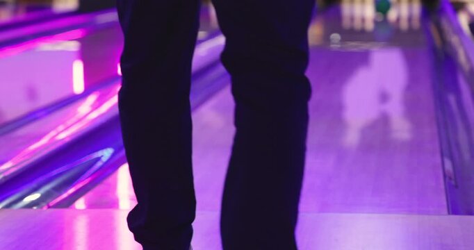 Bowling club play, group team of friends and colleagues playing, throwing a ball on the bowling alley lane, ball and pins, corporate party event in a mall amusement game center, tournament competition