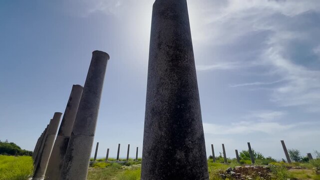 Ancient Roman stone columns ruins of Antiochia ad Cragum archaeological site in Turkey against blue sky