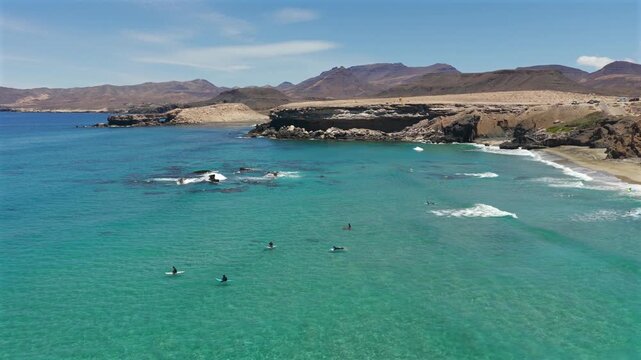 Aerial View of Beginners Catching Waves with a Surf School at Playa de Mal Nombre, Fuerteventura