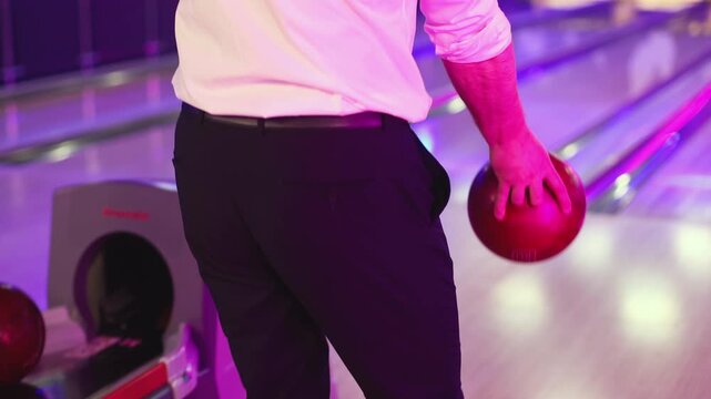 Bowling club play, group team of friends and colleagues playing, throwing a ball on the bowling alley lane, ball and pins, corporate party event in a mall amusement game center, tournament competition