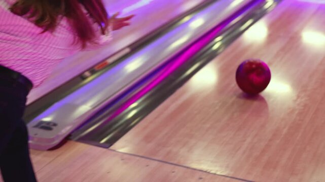 Bowling club play, group team of friends and colleagues playing, throwing a ball on the bowling alley lane, ball and pins, corporate party event in a mall amusement game center, tournament competition