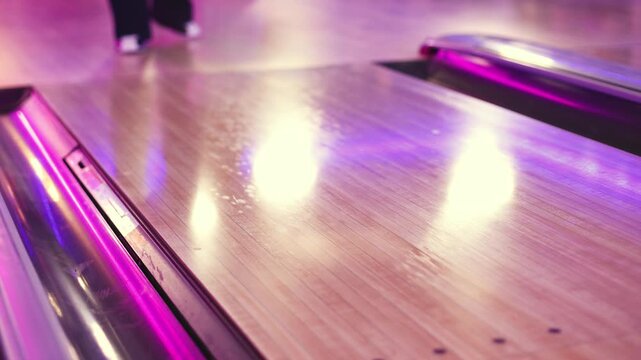 Bowling club play, group team of friends and colleagues playing, throwing a ball on the bowling alley lane, ball and pins, corporate party event in a mall amusement game center, tournament competition