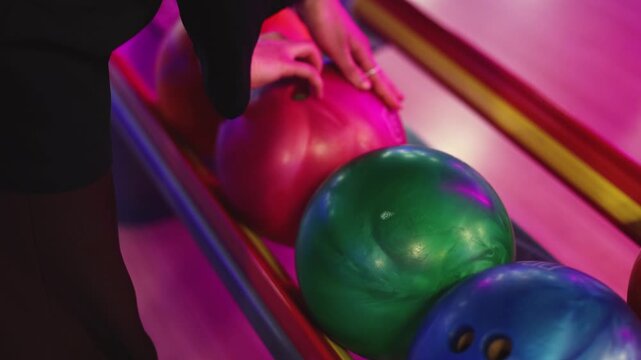 Bowling club play, group team of friends and colleagues playing, throwing a ball on the bowling alley lane, ball and pins, corporate party event in a mall amusement game center, tournament competition