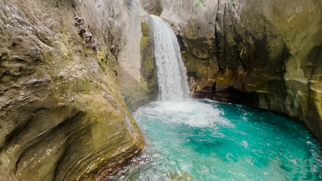 Scenic waterfall cascading through rocky Sapadere Canyon in Turkey surrounded by lush greenery