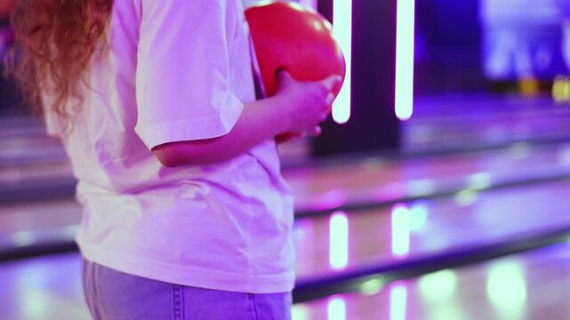 Bowling club play, group team of friends and colleagues playing, throwing a ball on the bowling alley lane, ball and pins, corporate party event in a mall amusement game center, tournament competition