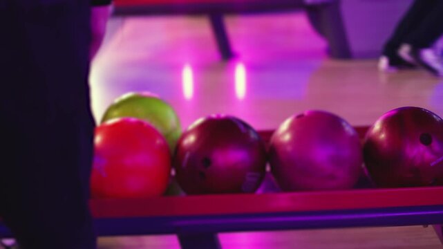 Bowling club play, group team of friends and colleagues playing, throwing a ball on the bowling alley lane, ball and pins, corporate party event in a mall amusement game center, tournament competition