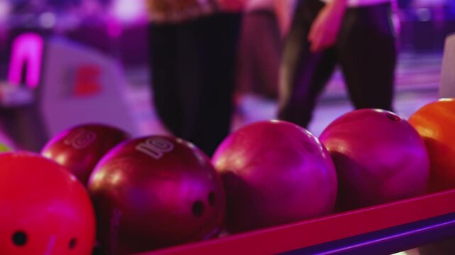 Bowling club play, group team of friends and colleagues playing, throwing a ball on the bowling alley lane, ball and pins, corporate party event in a mall amusement game center, tournament competition
