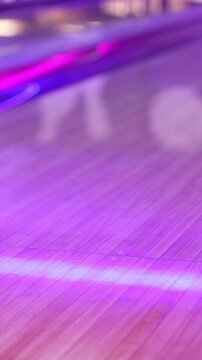 Bowling club play, group team of friends and colleagues playing, throwing a ball on the bowling alley lane, ball and pins, corporate party event in a mall amusement game center, tournament competition