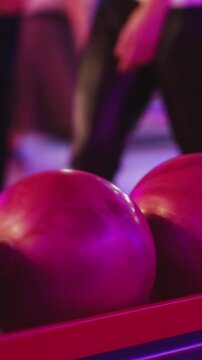 Bowling club play, group team of friends and colleagues playing, throwing a ball on the bowling alley lane, ball and pins, corporate party event in a mall amusement game center, tournament competition