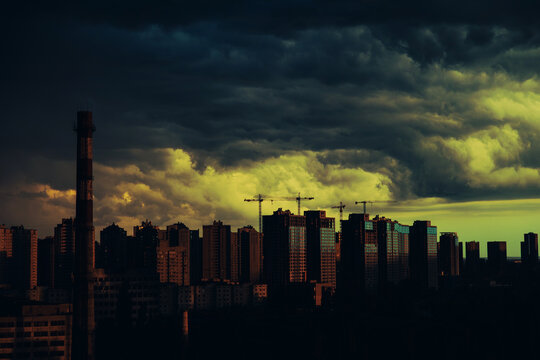 An incredible sunset in the big city and storm clouds hanging over the high-rise buildings