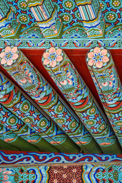 Beautiful fantasy mood of traditional dancheong patterns on ancient wooden rafters of a korean building