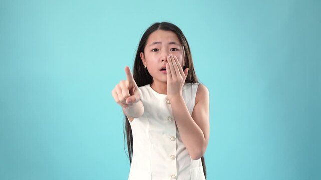 Shocked and scared asian girl closing mouth with her hands