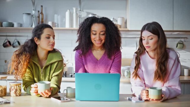 Women friends shopping laptop browsing e-commerce website at kitchen closeup.