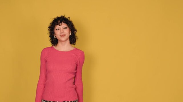 Young smiling woman waving hand for hello or goodbye gesture with copy space